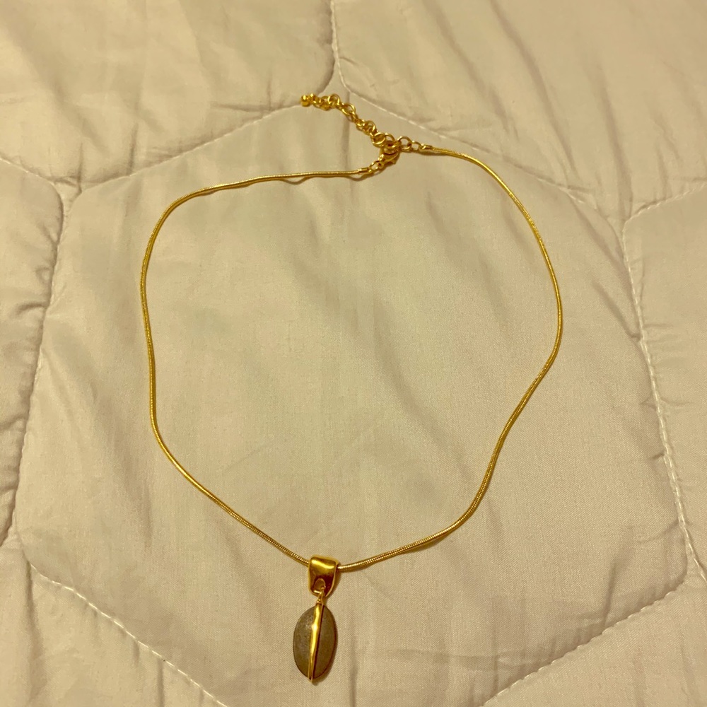 Gold-colored chain with oval pendant